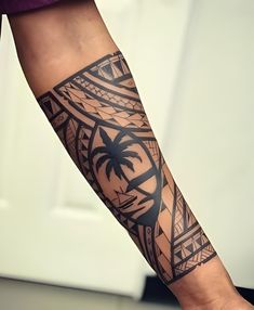 a man with a tattoo on his arm holding a cell phone in one hand and palm trees in the other