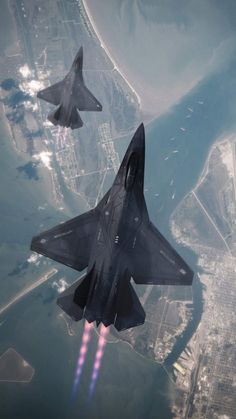 two fighter jets flying in the sky over an island and cityscape with water