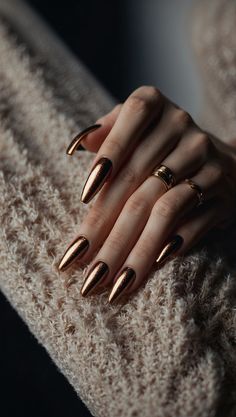 Close-up of a hand with long metallic bronze nails and rings on fingers Gold Bronze Nails, Cooper Chrome Nails, Bronze Nail Designs, Romantic Nails Designs, Bronze Nails Designs, Copper Nails Designs, Hollywood Prom, Brass Nails, Metallic Nails Design