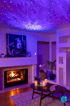 a living room filled with furniture and a fire place next to a tv mounted on the wall