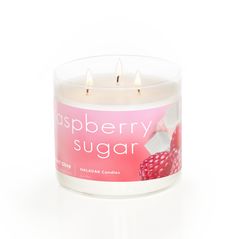 raspberry sugar candle in a clear glass container on a white background with the words raspberry sugar printed on it