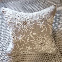 a close up of a pillow on a bed