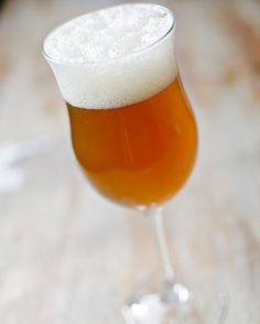 a glass filled with liquid sitting on top of a table