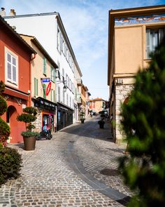 a cobblestone street with shops on both sides