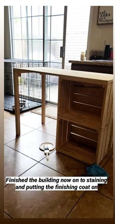 a kitchen counter with a measuring tape on the floor in front of it and an open window