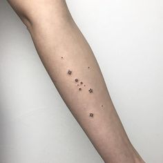 a person's arm with tiny stars on it