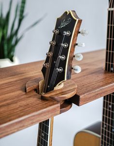 an acoustic guitar resting on the edge of a table