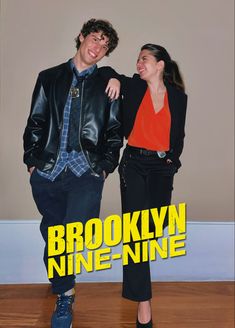 a man and woman standing next to each other in front of a sign that says brooklyn nine - nine