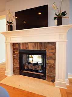 a fireplace with a television above it in a living room