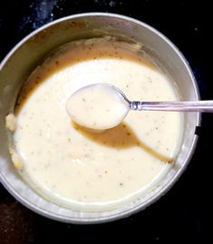 a spoon in a bowl filled with liquid