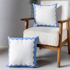 a chair with two pillows sitting next to it