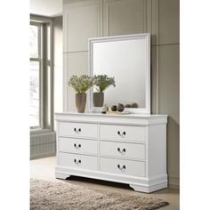 a white dresser and mirror in a room