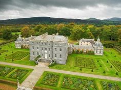 an aerial view of a large house with many gardens