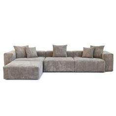 a large sectional couch with pillows on it's back end and two sides facing each other