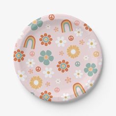 a pink paper plate with flowers, rainbows and peace signs on the front side