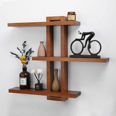 three wooden shelves with vases and other items on them