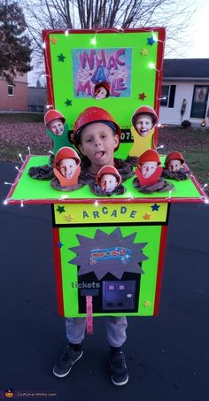 a young boy wearing a costume made out of an arcade machine