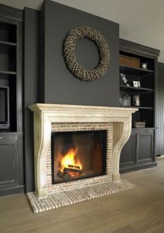 a living room filled with furniture and a fire place in front of a tv mounted on a wall