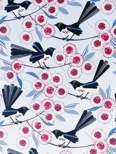 a blue and white fabric with black birds on it, surrounded by pink flower petals