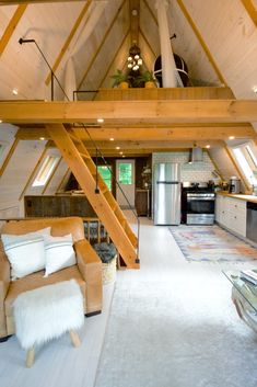 a loft with an open floor plan and wooden beams