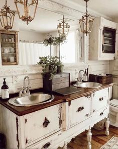 a bathroom with two sinks and a toilet