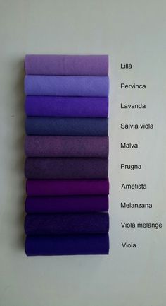 the different colors of yoga mats stacked on top of each other, with names in spanish