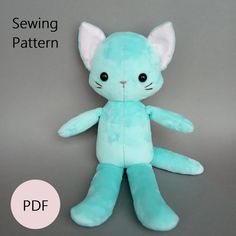 a blue stuffed cat sitting on top of a gray surface with the text sewing pattern below it