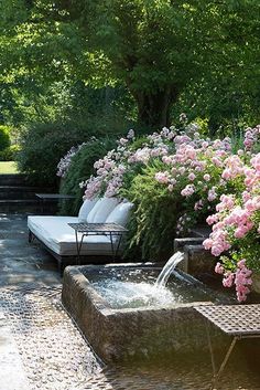 an outdoor patio with seating and flowers in blooming trees around the fire hydrant