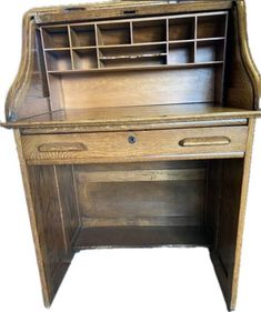 an old wooden desk with drawers on it