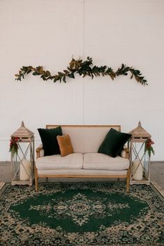 a white couch sitting on top of a green rug