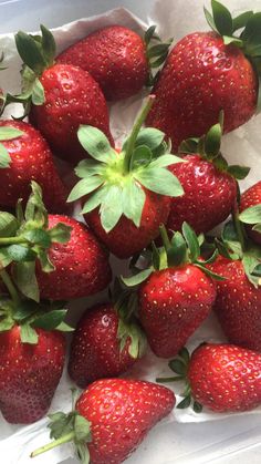 a bowl full of fresh strawberries on a table