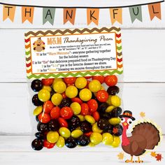 a turkey candy filled with thanksgiving candies in front of a happy thanksgiving sign and banner