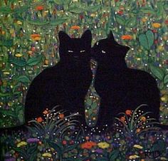 two black cats sitting next to each other in front of plants and flowers on the ground