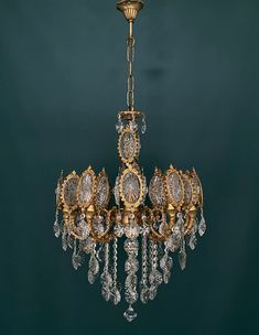 an antique chandelier hanging from the ceiling