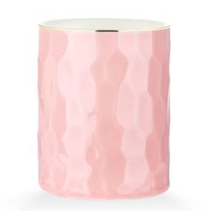 a pink and white vase with gold rim