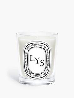 a glass candle with the words lyss on it in black and white lettering