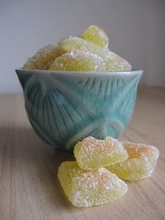 a bowl filled with sugar covered candies on top of a wooden table