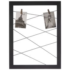 two pictures hanging on a clothes line in front of the eiffel tower