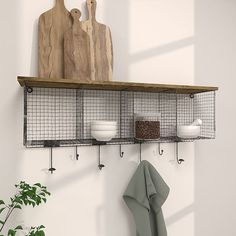 a kitchen shelf with wire and wood shelves on the wall next to a potted plant