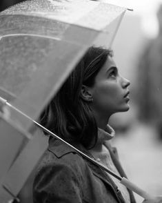 a woman holding an umbrella in the rain