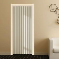 a living room with a white couch and a radiator in the wall next to it