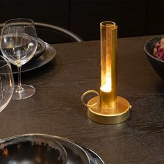 a light that is sitting on top of a table next to some plates and bowls