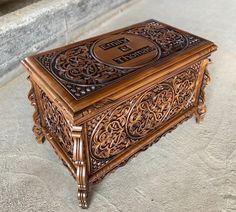 an ornate wooden box sitting on the ground