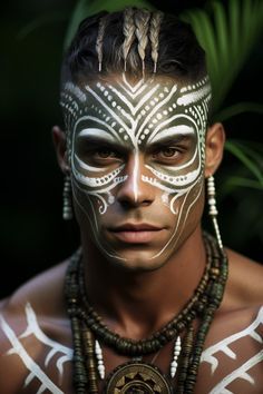 a man with white face paint on his face and necklaces around his neck is looking at the camera