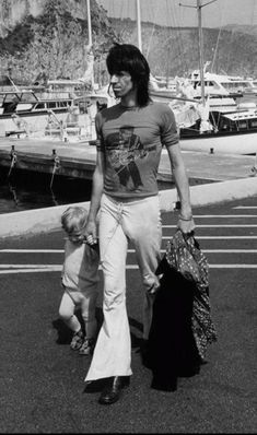 an old photo of a woman walking with two children