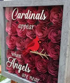 the cardinal is appear when angels are near sign made out of paper roses and wood