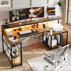 a computer desk with two computers on it and a chair in front of the desk