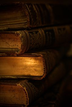 several old books stacked on top of each other