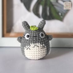 a crocheted totoro is sitting on a table