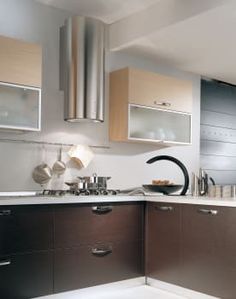 a modern kitchen with stainless steel appliances and wood cabinets